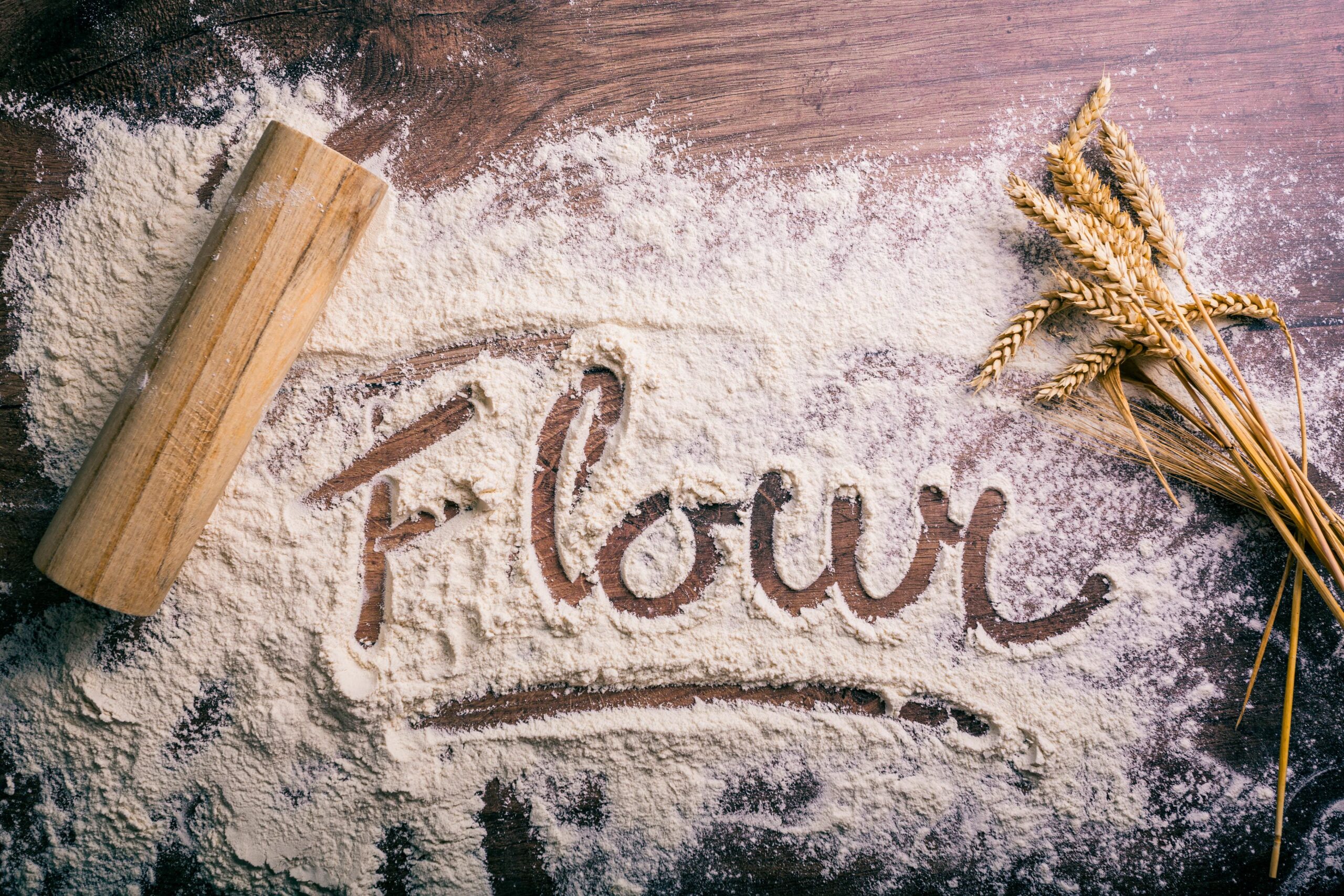 Cake flour next to all-purpose flour, side-by-side comparison in bowls on a kitchen counter