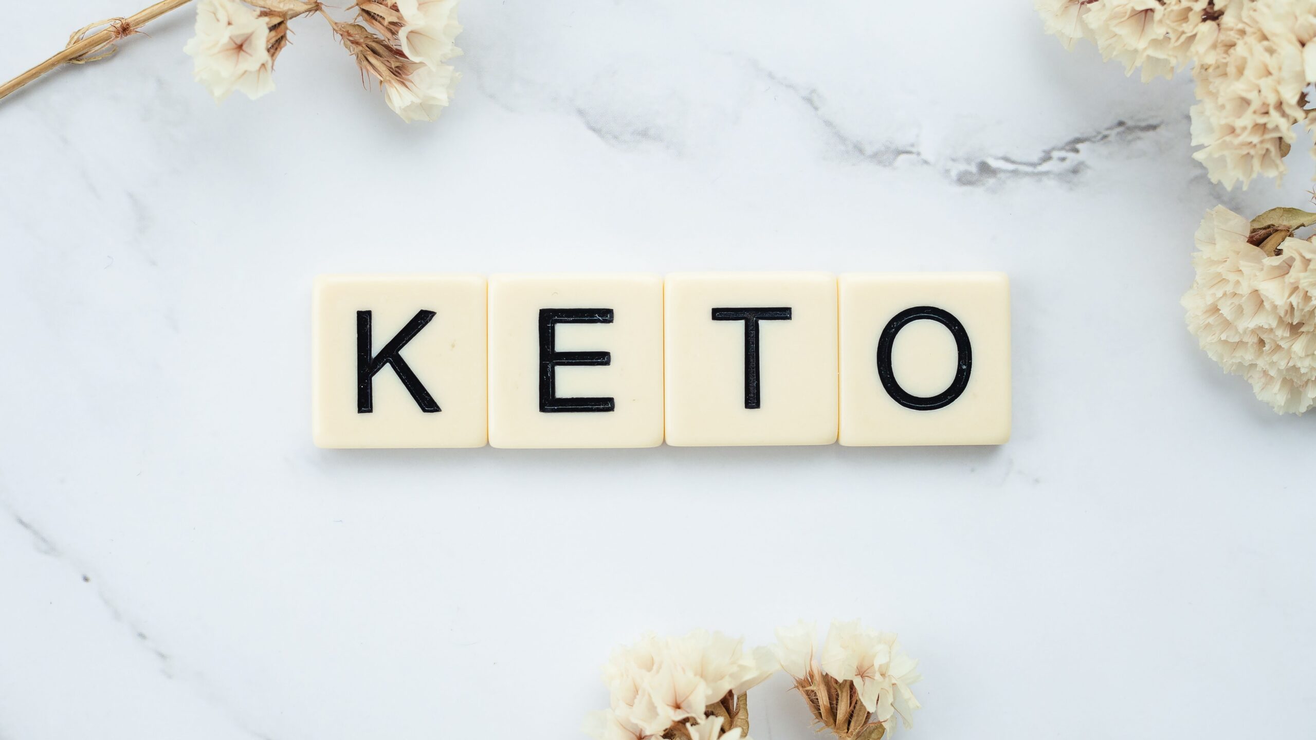 Keto baking ingredients including almond flour and low-carb sweetener arranged overhead