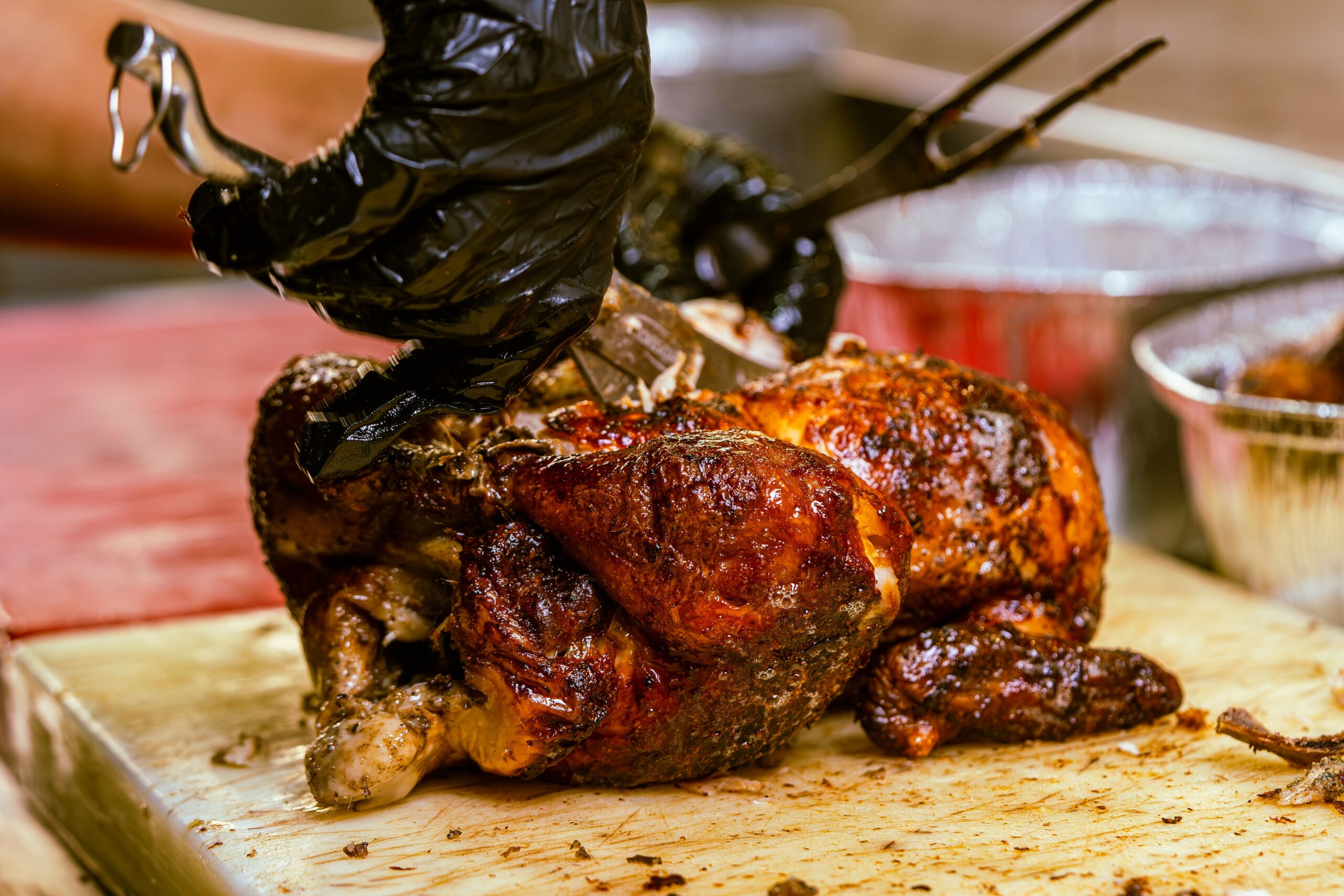 Roasted chicken on a cutting board ready for temperature checking and resting