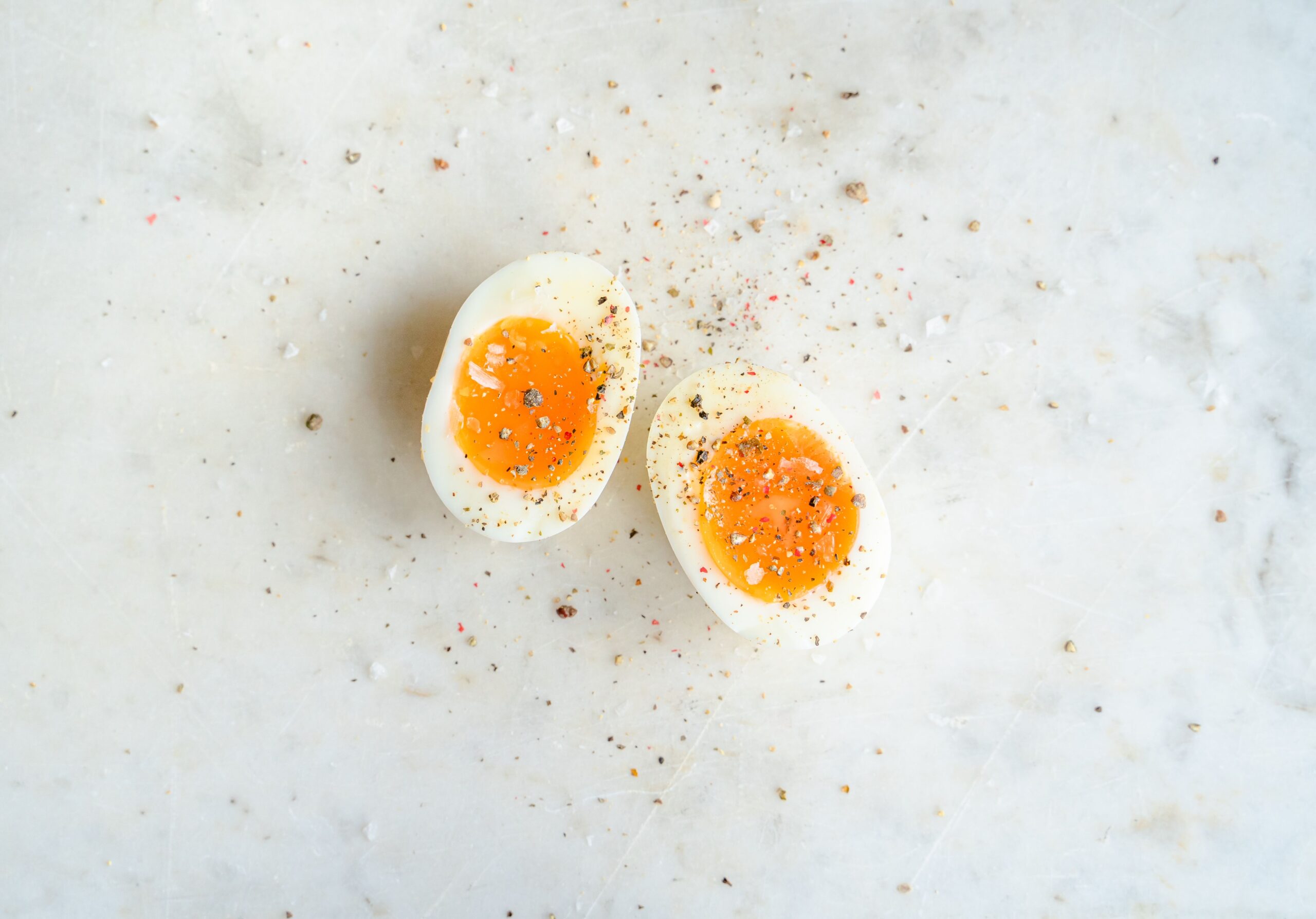 Halved soft-boiled egg showing a rich jammy yolk and set egg white